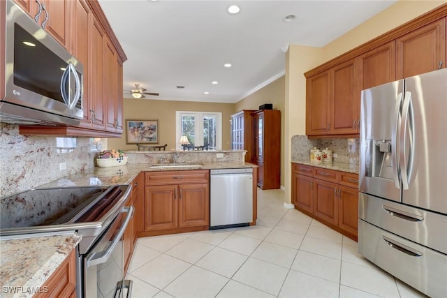 kitchen with kitchen peninsula, tasteful backsplash, stainless steel appliances, ceiling fan, and sink