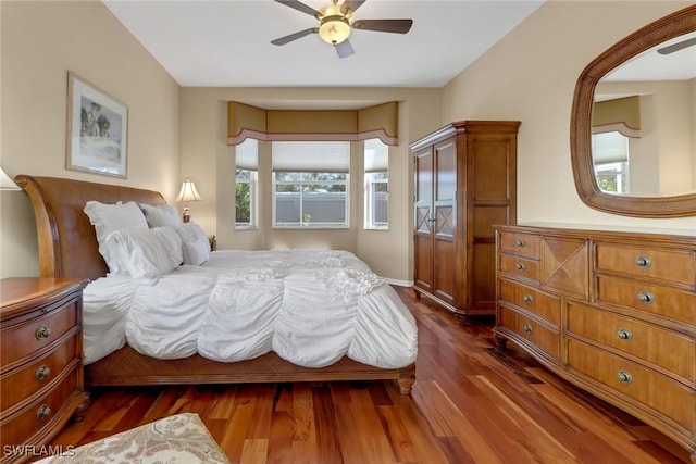 bedroom with ceiling fan and dark hardwood / wood-style flooring