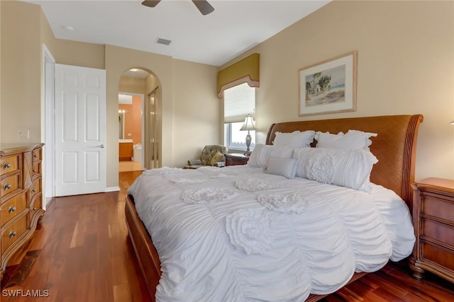 bedroom with ensuite bathroom, ceiling fan, and hardwood / wood-style flooring