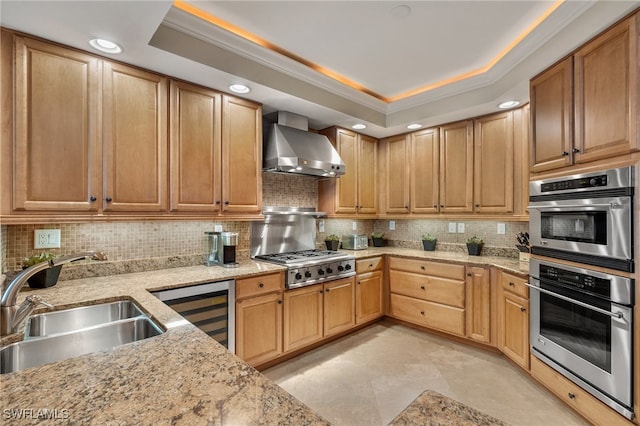 285 Grande Way Unit 705, Naples, FL 34110 - kitchen with wall chimney exhaust hood, double oven, beverage cooler, decorative backsplash, and light stone countertops