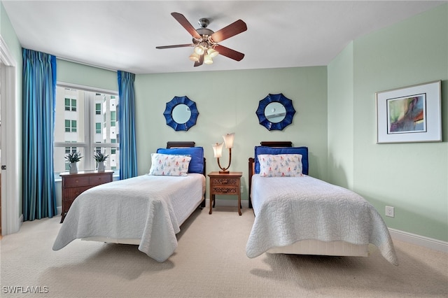 bedroom with ceiling fan and light colored carpet