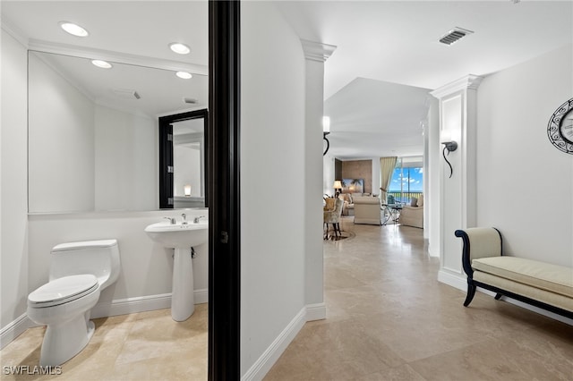 interior space featuring ornate columns and toilet