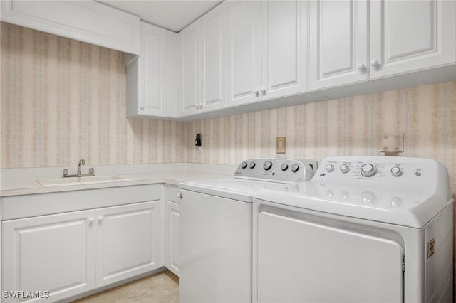 285 Grande Way Unit 705, Naples, FL 34110 - laundry area with wallpapered walls, cabinet space, and separate washer and dryer
