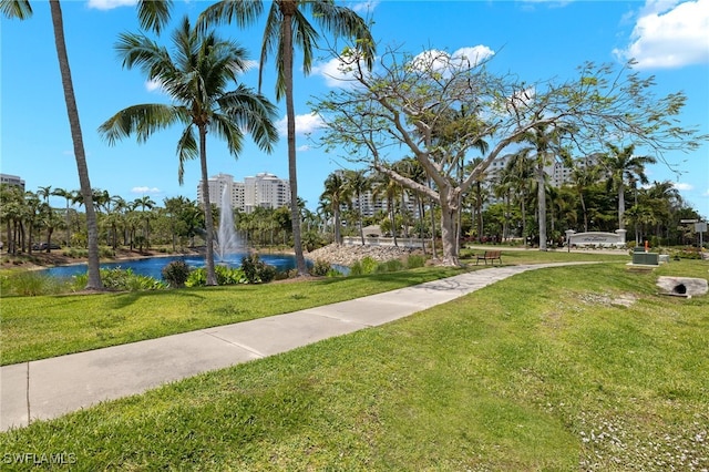 surrounding community with a lawn and a water view