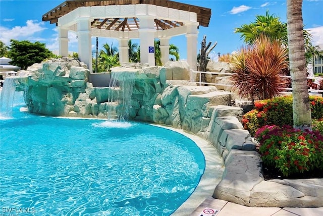 view of pool with pool water feature