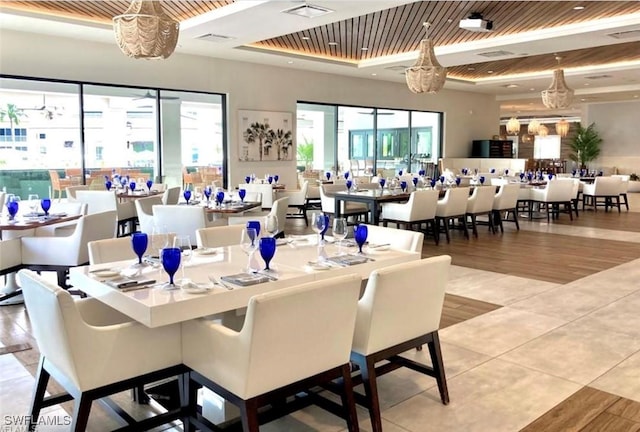 285 Grande Way Unit 705, Naples, FL 34110 - dining area with a tray ceiling, wooden ceiling, and wood finished floors
