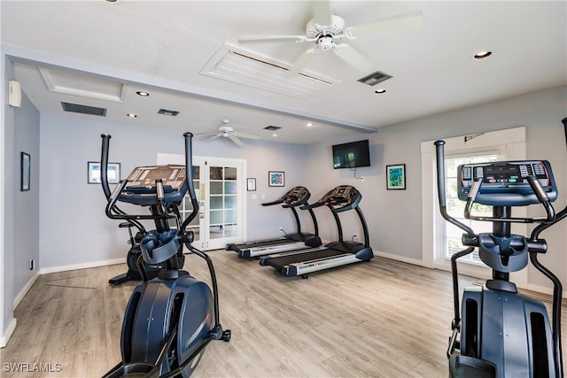 exercise room featuring ceiling fan and light wood-type flooring