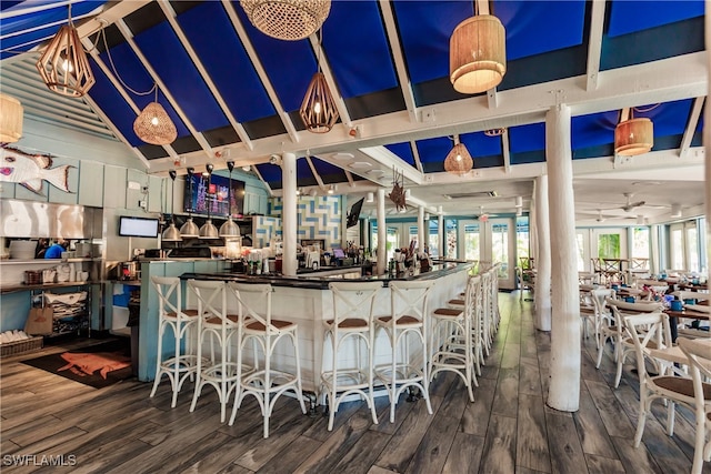 bar with hardwood / wood-style floors, vaulted ceiling, and french doors