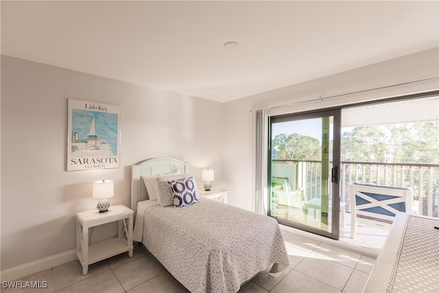 bedroom with access to outside and light tile patterned flooring