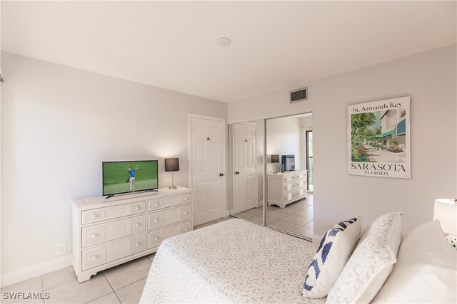 bedroom featuring a closet and light tile patterned flooring