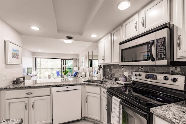 kitchen featuring white cabinets, sink, stainless steel appliances, and tasteful backsplash