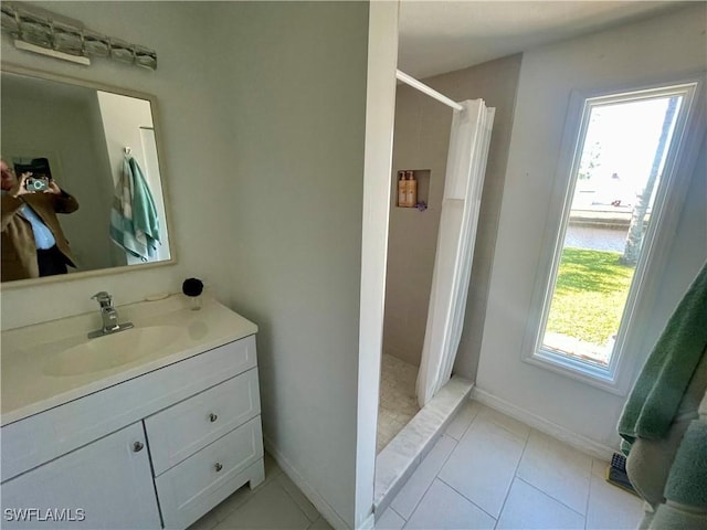 bathroom with a shower with curtain, vanity, tile patterned floors, and plenty of natural light