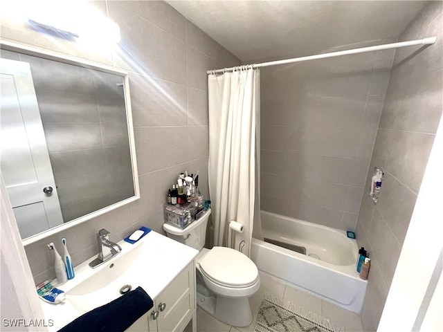 full bathroom with tile patterned flooring, tile walls, toilet, vanity, and shower / tub combo