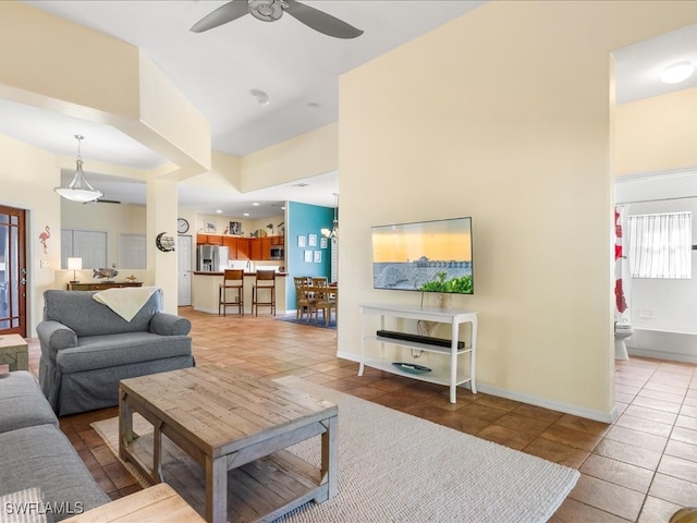 tiled living room with ceiling fan