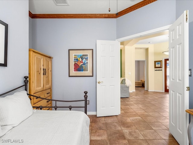 bedroom with a high ceiling and light tile patterned floors