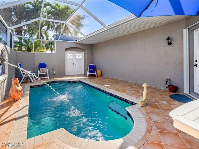 view of pool featuring a lanai, pool water feature, and a patio