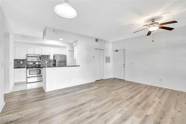 unfurnished living room with ceiling fan and light hardwood / wood-style floors