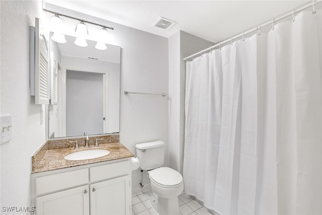 bathroom featuring toilet, vanity, and tile patterned floors