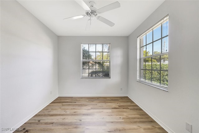 unfurnished room featuring light hardwood / wood-style flooring, plenty of natural light, and ceiling fan