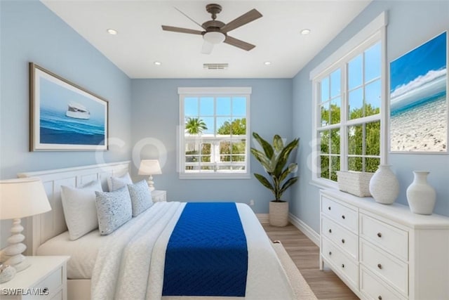 bedroom featuring ceiling fan and light hardwood / wood-style flooring