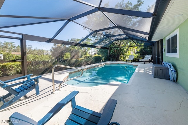 view of swimming pool with glass enclosure and a patio area