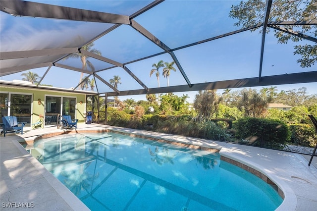 view of pool with a lanai and a patio