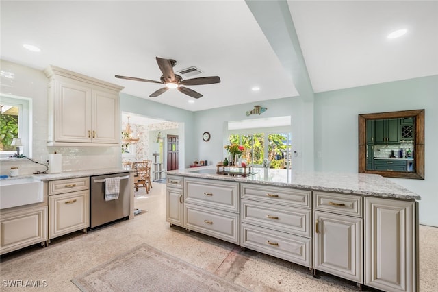 kitchen with light stone countertops, plenty of natural light, stainless steel dishwasher, and ceiling fan