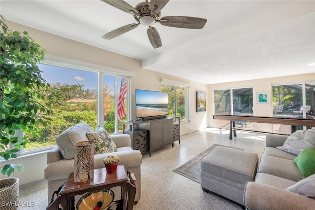 living room with ceiling fan and plenty of natural light