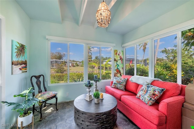 sunroom with a notable chandelier and beamed ceiling