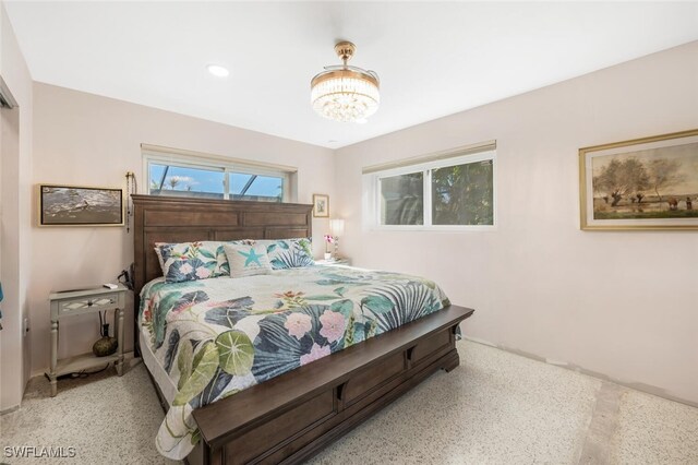 bedroom featuring a notable chandelier