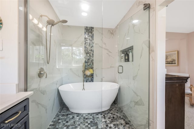 bathroom with vanity, separate shower and tub, and tile walls