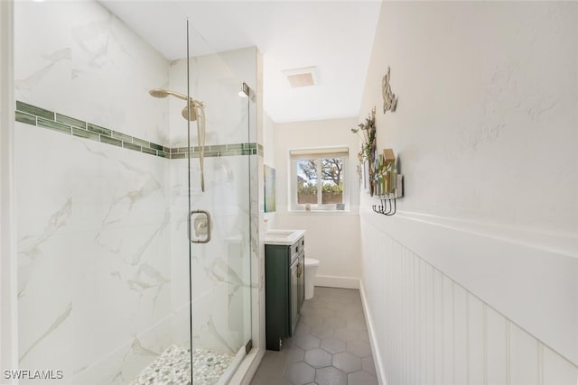 bathroom with an enclosed shower, vanity, and toilet