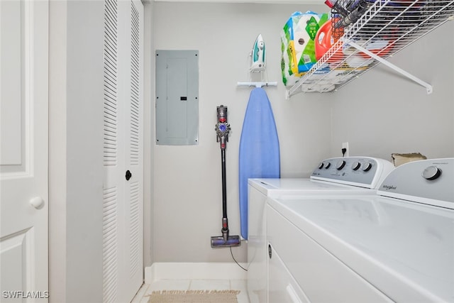 laundry room featuring electric panel, light tile patterned flooring, and independent washer and dryer