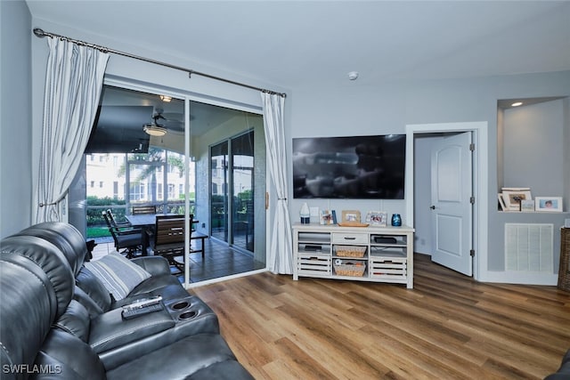 living room with wood-type flooring and ceiling fan