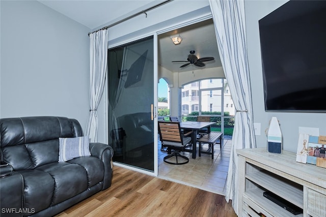 living room with wood-type flooring and ceiling fan