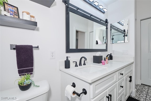 bathroom featuring vanity and toilet