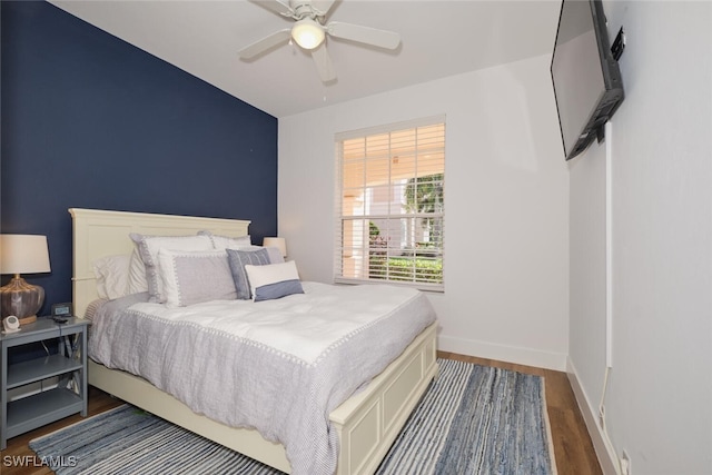 bedroom featuring ceiling fan and dark wood-type flooring