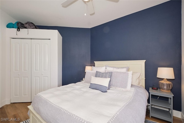 bedroom with ceiling fan, a closet, and hardwood / wood-style floors