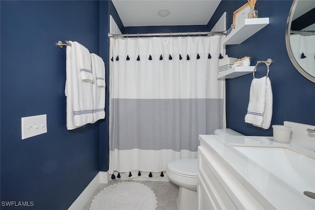 bathroom with tile patterned floors, vanity, curtained shower, and toilet