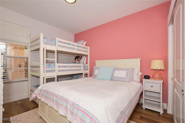 bedroom with dark wood-type flooring