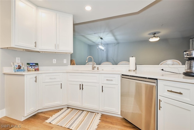 kitchen featuring white cabinets, stainless steel dishwasher, and sink