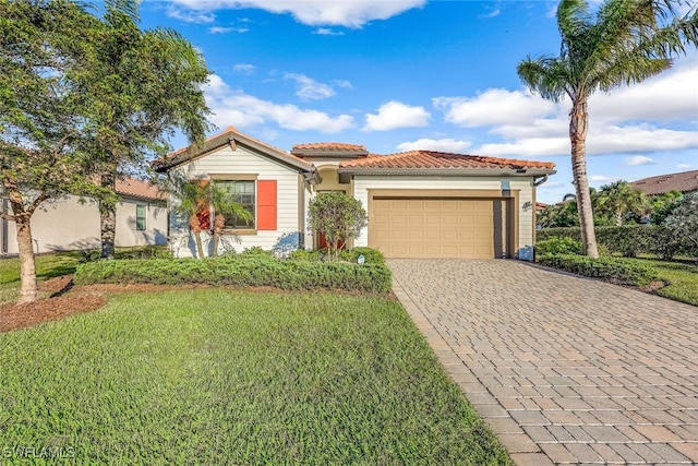 mediterranean / spanish house with a front lawn and a garage