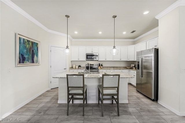 kitchen featuring a center island with sink, white cabinets, stainless steel appliances, and decorative light fixtures