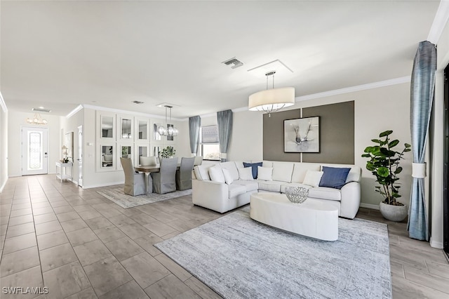 living room featuring ornamental molding, light hardwood / wood-style floors, and a notable chandelier