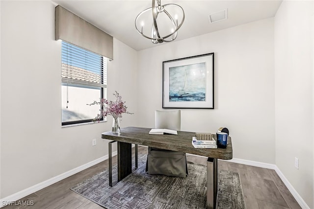 office area featuring dark wood-type flooring and a chandelier