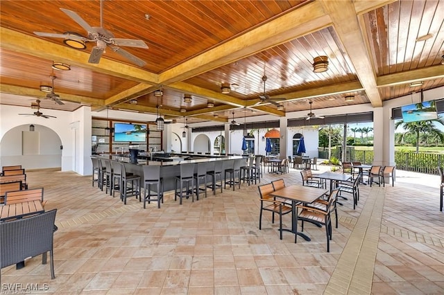 dining room featuring beam ceiling and wood ceiling