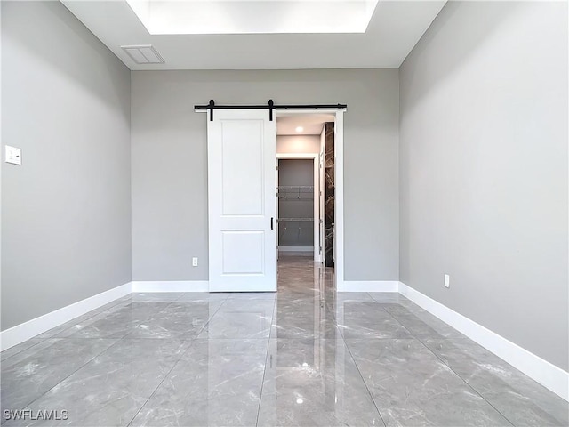 spare room with a barn door