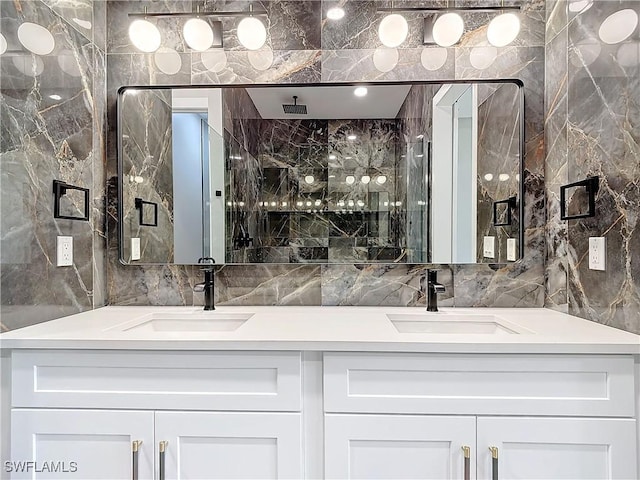 bathroom with vanity, a shower, and tile walls