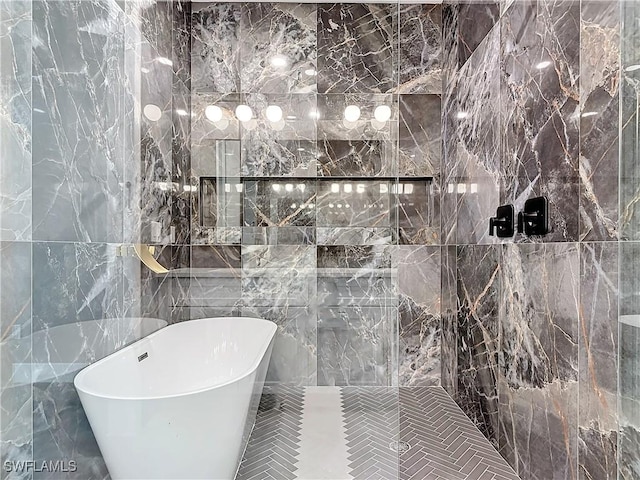 bathroom featuring a bathing tub and tile walls