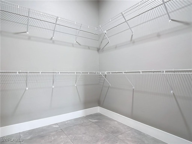 spacious closet with tile patterned flooring